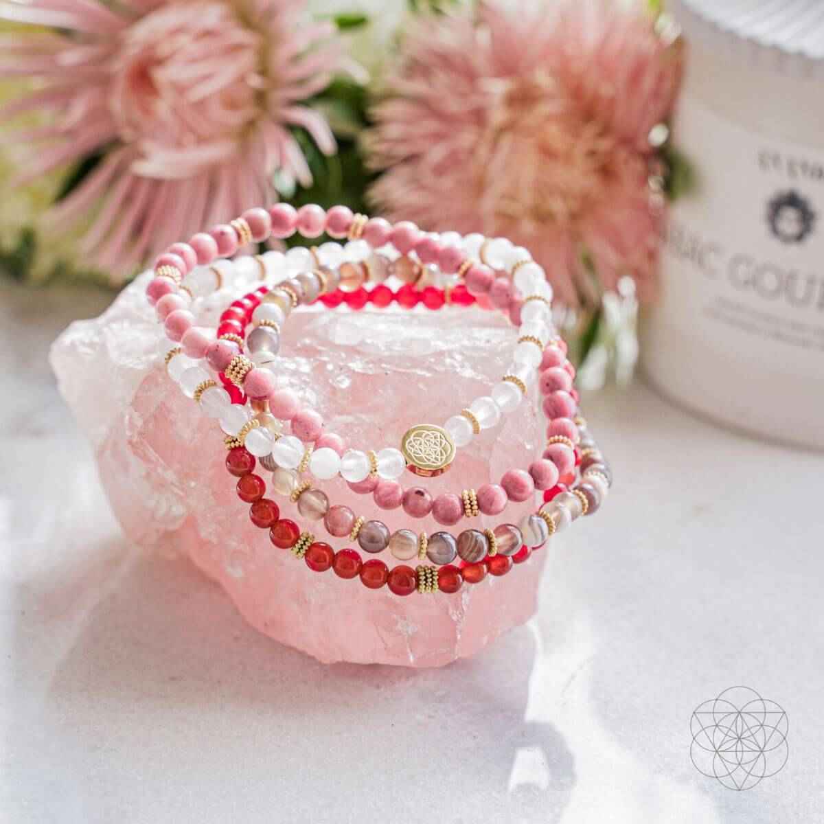 Bracelet set of 4 with red and pink bead wraps, white beads, and gold-tone charms