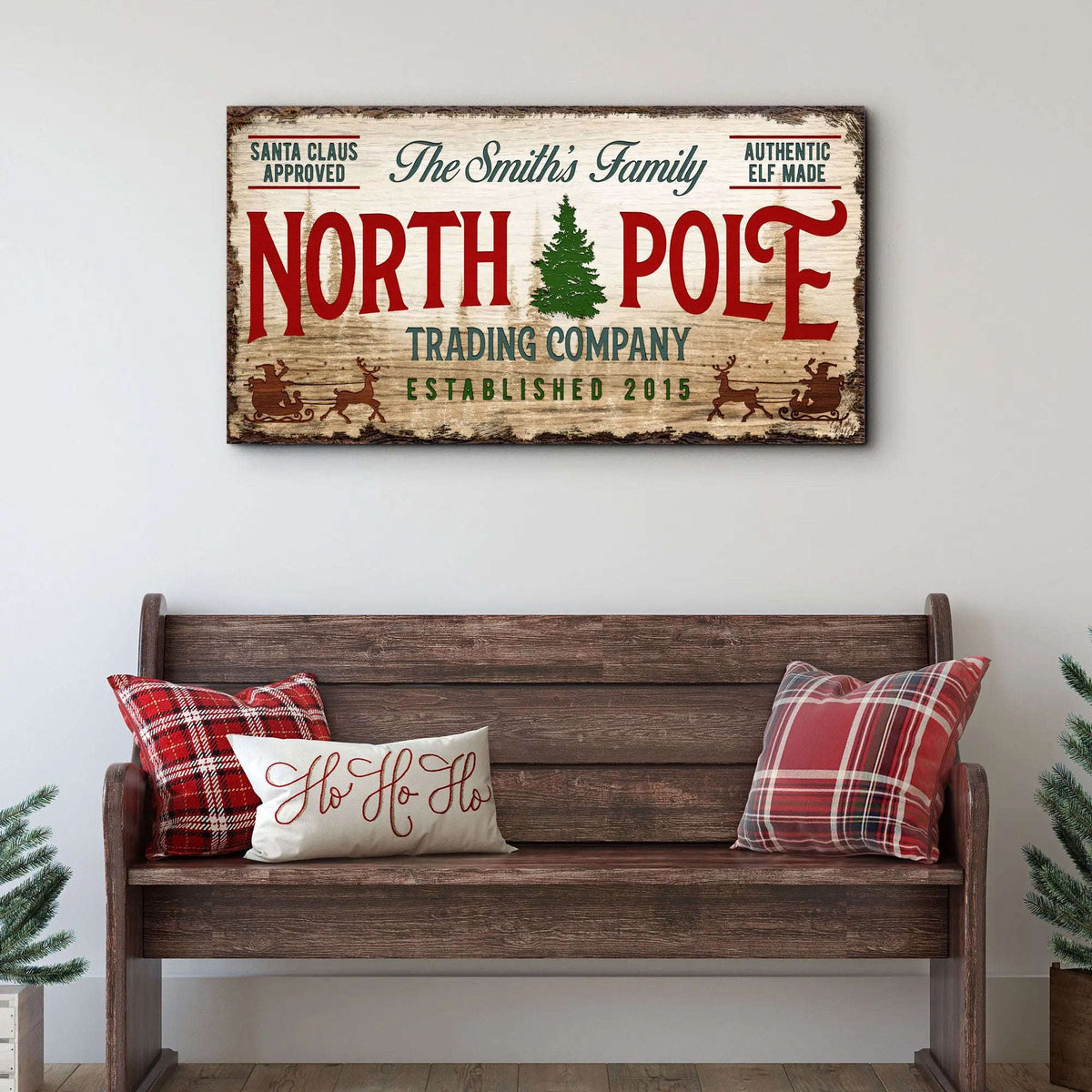 Vintage North Pole trading company wall sign on rectangular wood canvas, red and green text