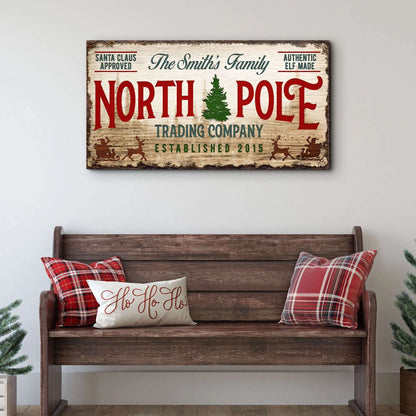 Vintage North Pole trading company wall sign on rectangular wood canvas, red and green text