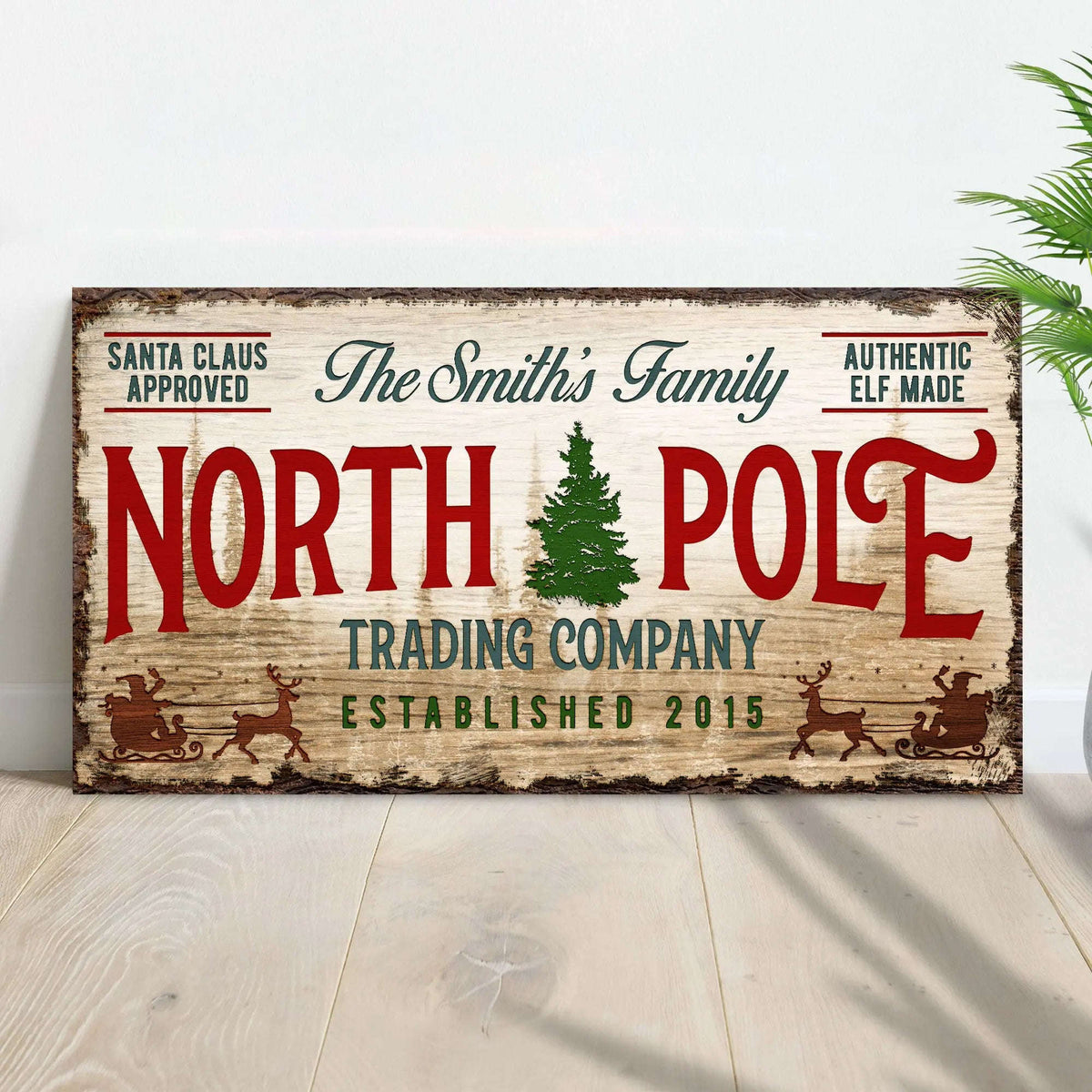 Rectangular vintage wall sign reading North Pole with green tree graphic and red accents
