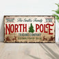 Rectangular vintage wall sign reading North Pole with green tree graphic and red accents