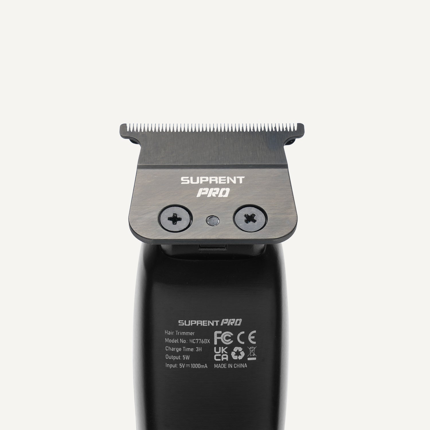 Hair clipper blade guard and control buttons on black housing