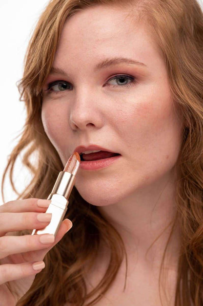 Color-changing flower lip gloss on lips, silver tube with pink flower tip
