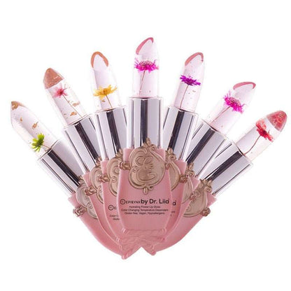 Set of flower-themed color-changing lip glosses in clear tubes with pink bases