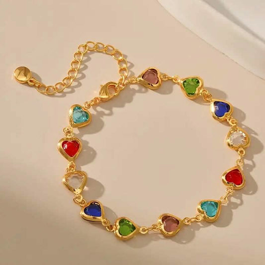 Gold-tone heart-stone bracelet with assorted colored heart charms on a chain