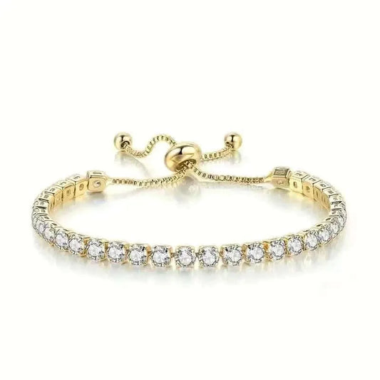 Gold-tone tennis bracelet with clear stones and central clasp detail