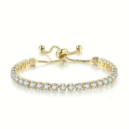 Gold-tone tennis bracelet with clear stones and central clasp detail