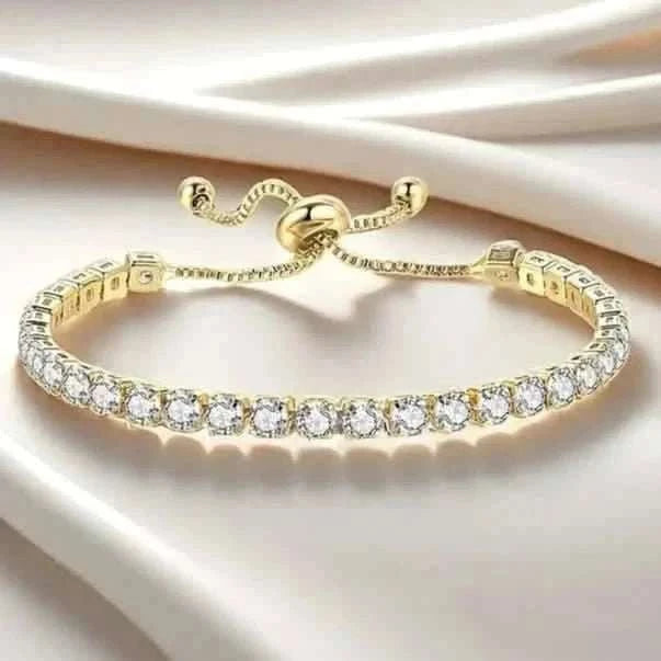 Gold-tone tennis bracelet with clear round stones and adjustable clasp