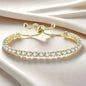 Gold-tone tennis bracelet with clear round stones and adjustable clasp