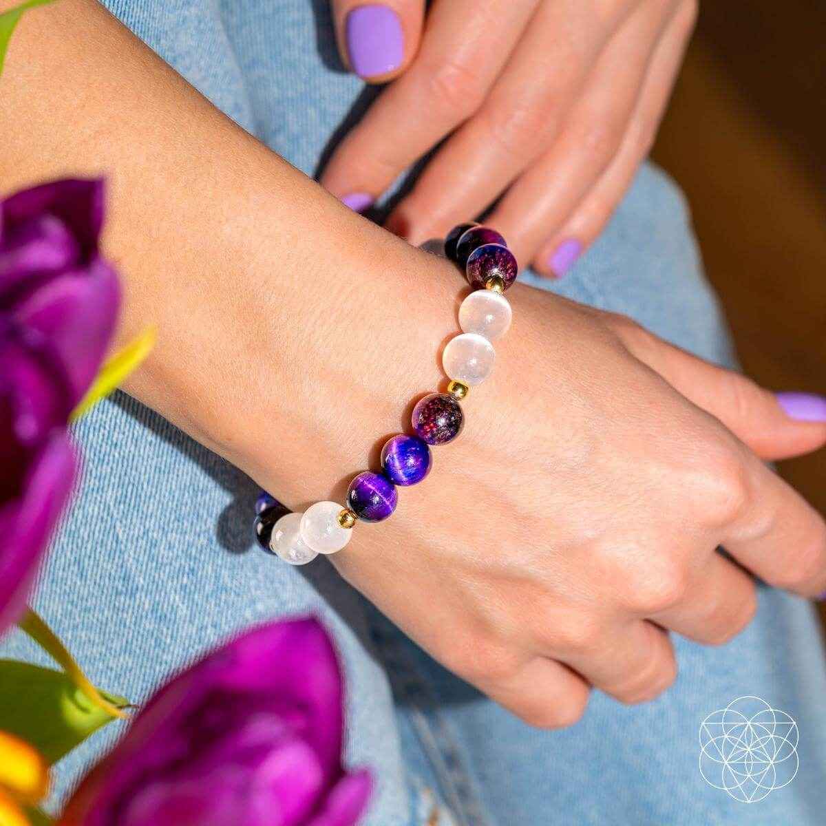Purple and white bead bracelet on wrist, round beads with gold spacer beads