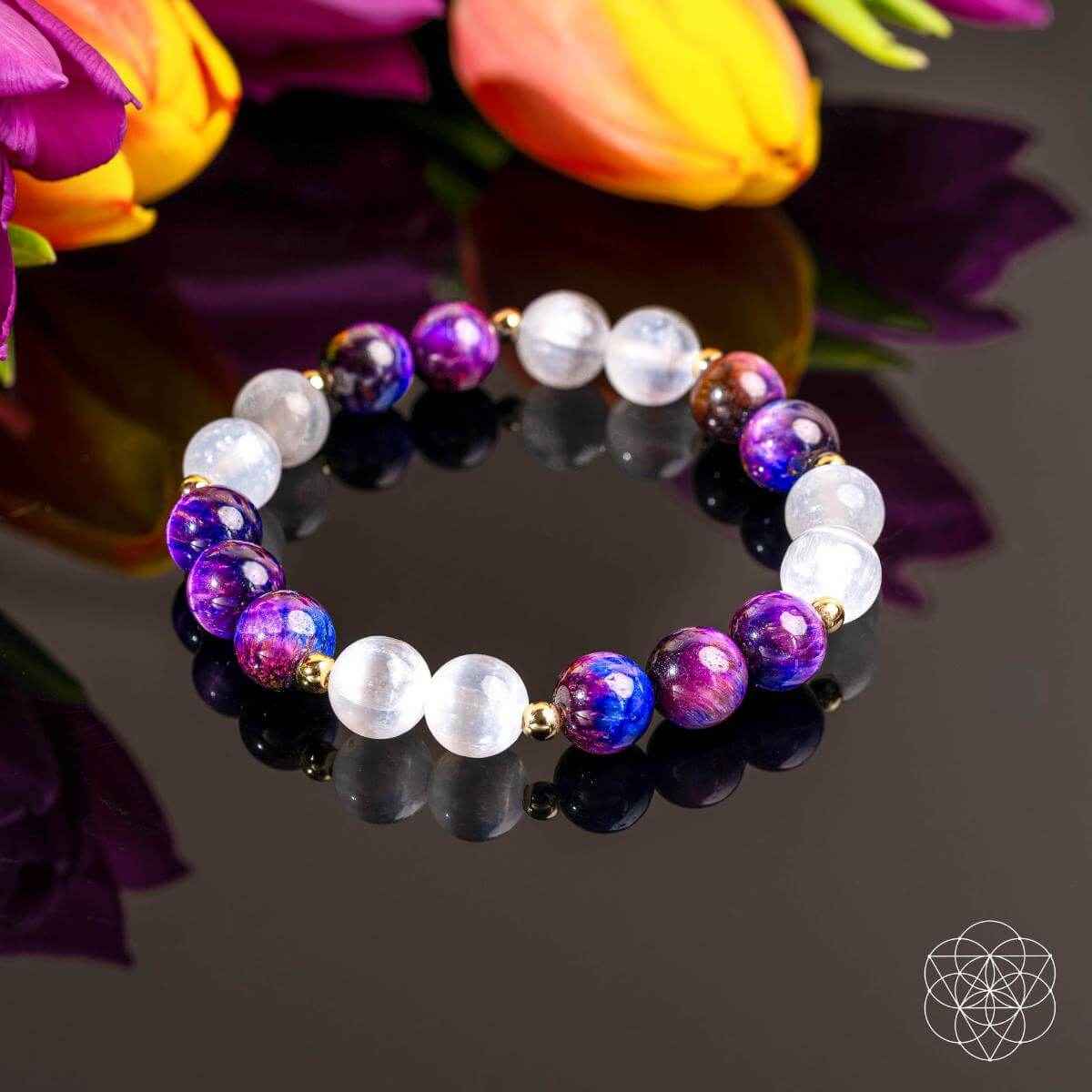 Purple and white gemstone bead bracelet with gold accents, round beads