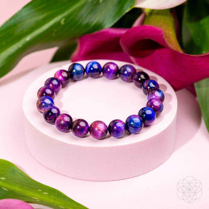 Beaded purple and blue bracelet with round gemstone beads on a display plate