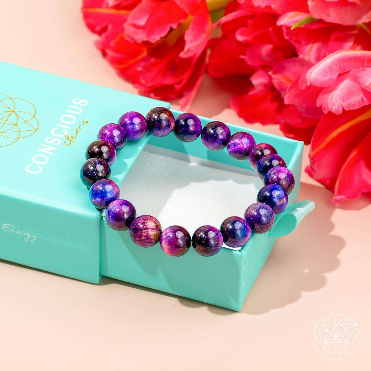 Purple and blue beaded bracelet on a teal gift box with round stone beads