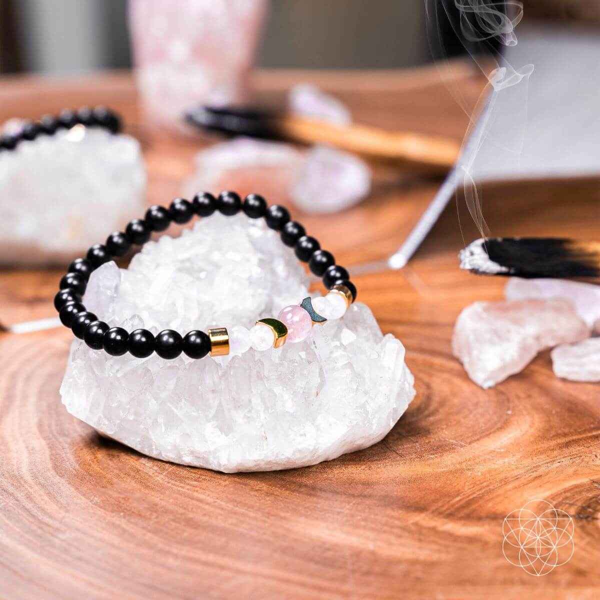 Shungite bracelet on crystal cluster with black beads and rose quartz-like pink stones
