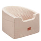 Brown barrel-style pet booster car seat with quilted top and side logo patch