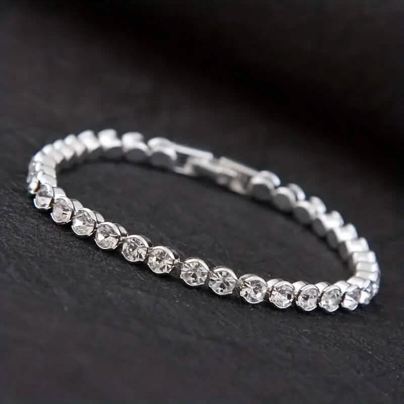 Silver-tone rhinestone tennis bracelet with round stones and box clasp detail