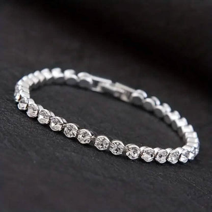 Silver-tone rhinestone tennis bracelet with round stones and box clasp detail