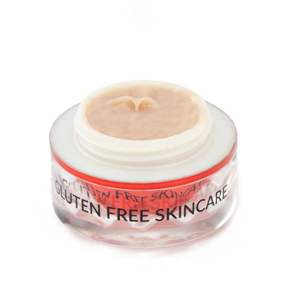 Eye cream jar with beige cream surface and red rim, labeled gluten free