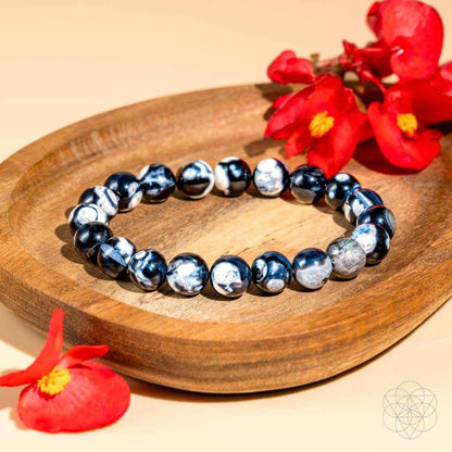 Blue and white stone bead bracelet on wooden dish