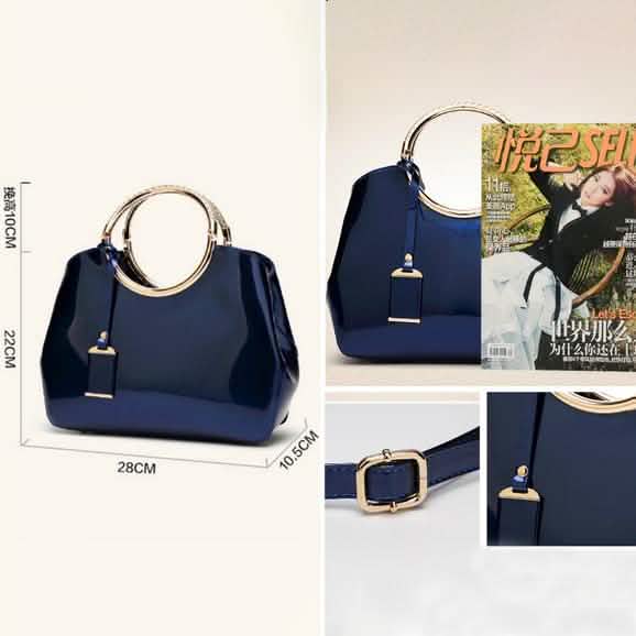 Navy handbag with gold ring handle and hanging charm tag, size shown