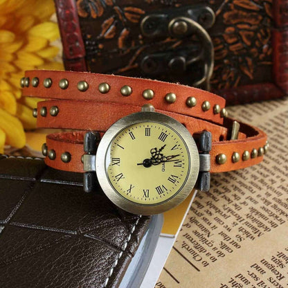 Retro leather belt watch with cream dial and studded orange-brown leather belt.