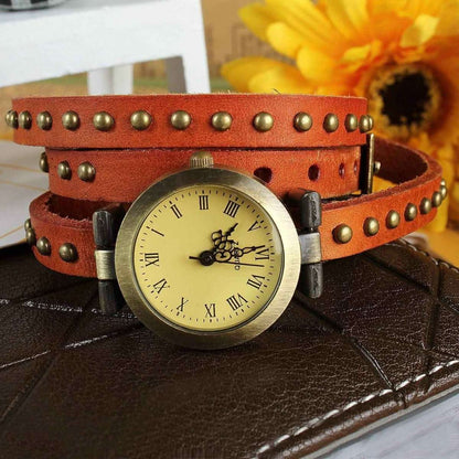 Retro leather belt watch with cream dial, studded orange-brown leather strap.