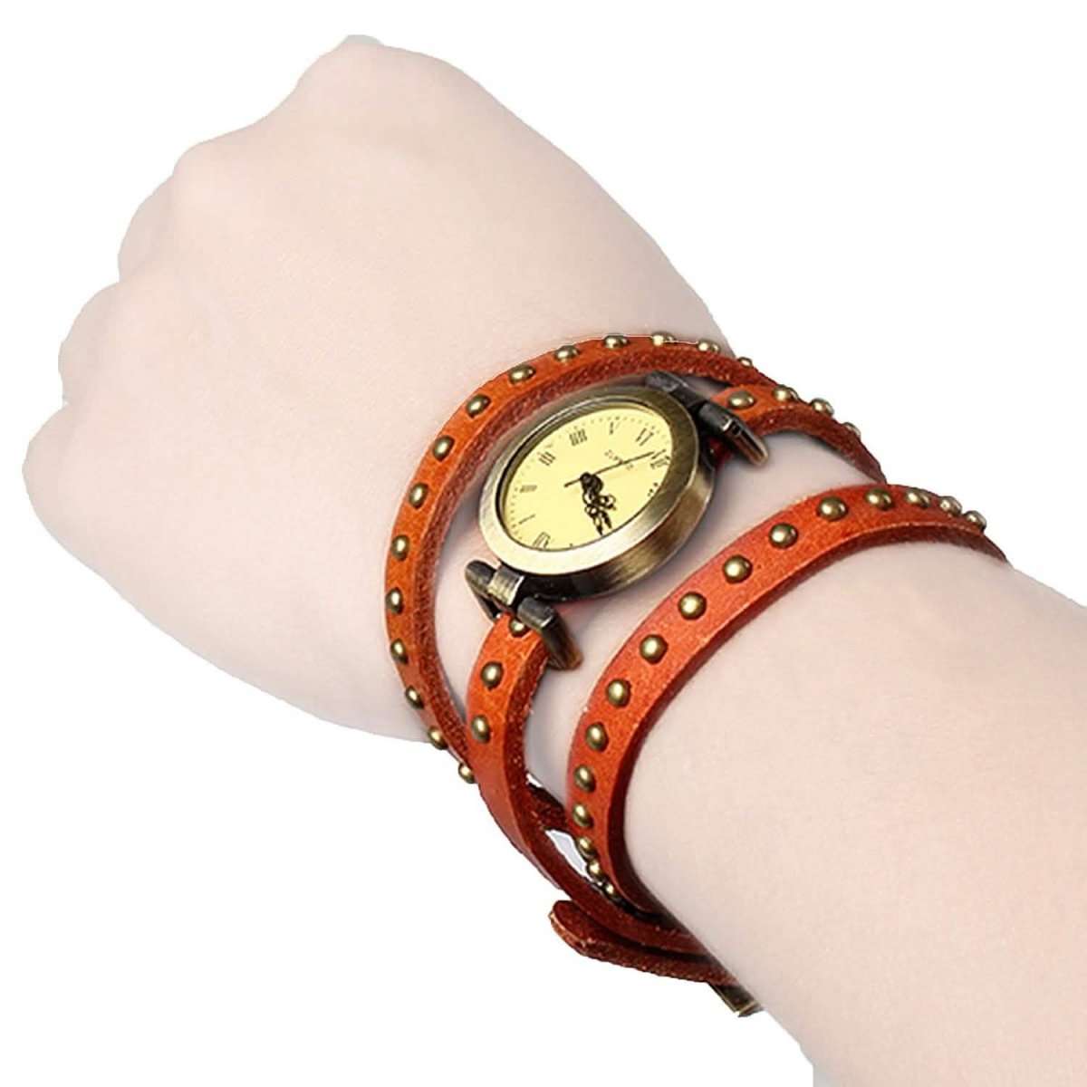 Retro leather belt watch with cream dial, studded rust-brown strap on wrist.