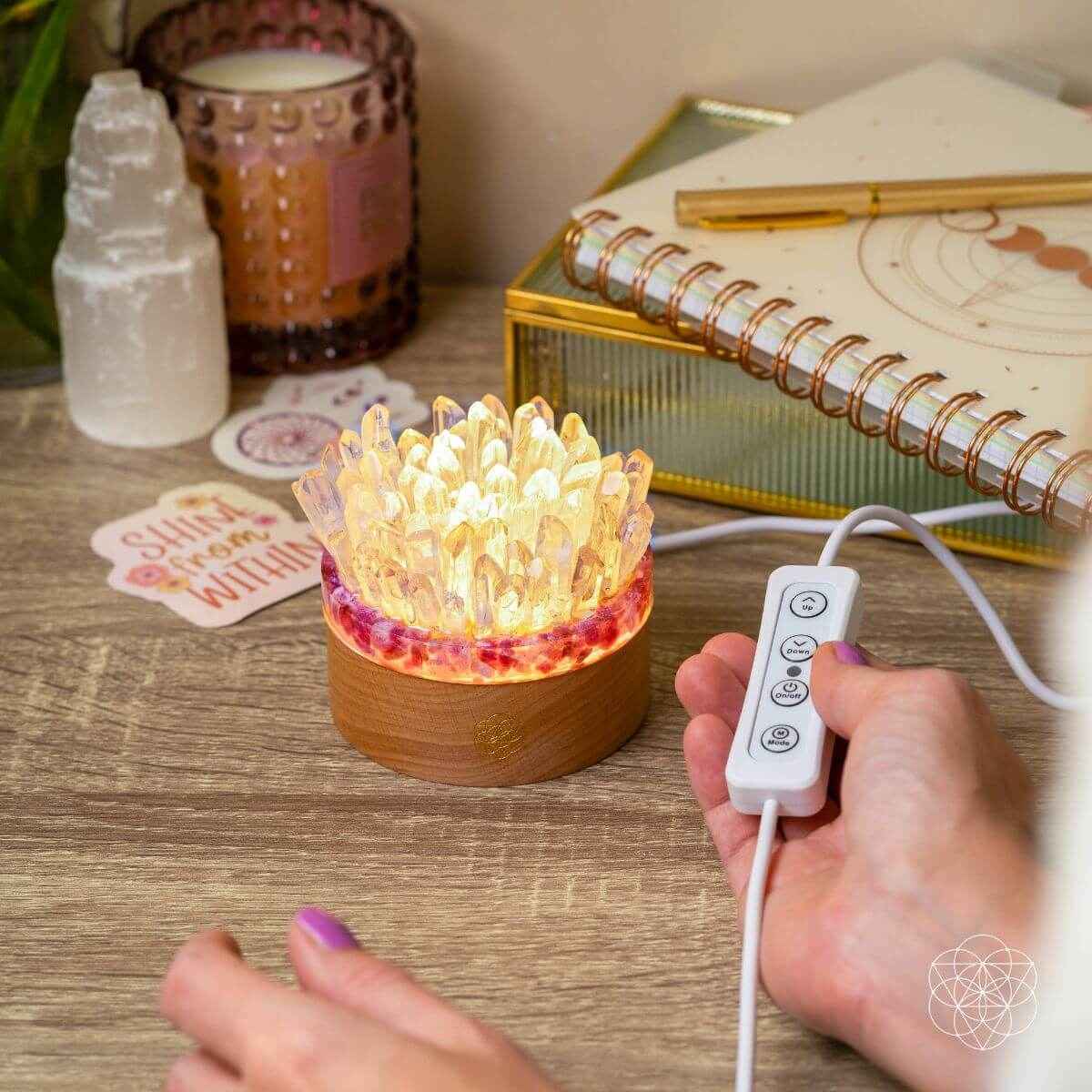 Quartz and tourmaline crystal lamp with remote control, clear crystals glowing on wood base