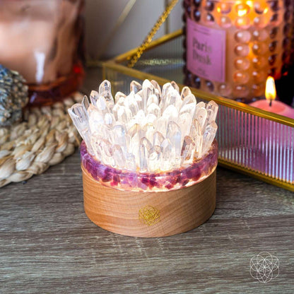 Quartz and tourmaline crystal lamp with clear crystal cluster, wooden base, warm lit glow