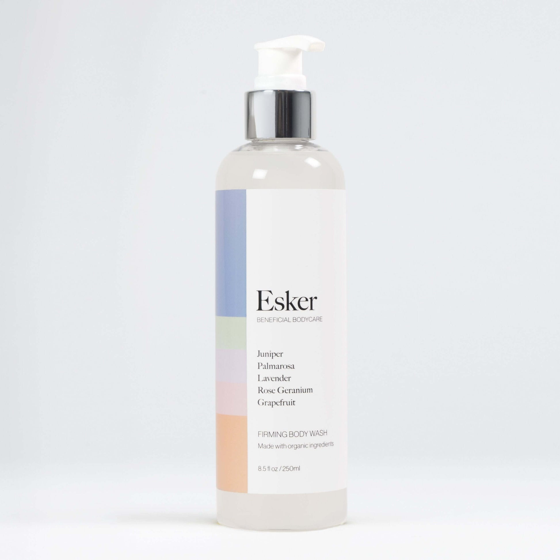 Esker firming body wash pump bottle with clear liquid, white label and silver top