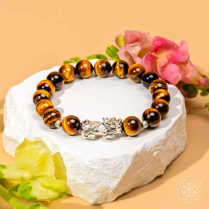 Round tiger’s eye bead bracelet with silver Pixiu charm on dark and amber beads