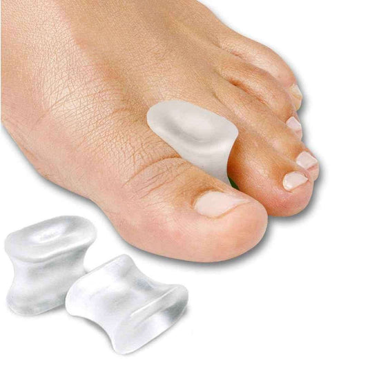 Gel toe separators: two white gel pads separating toes on a bare foot
