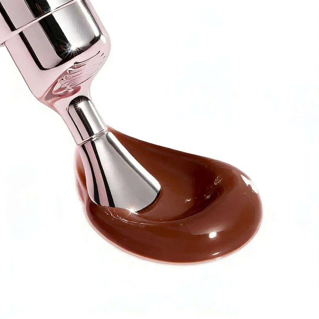 Brown lip gloss swatch with metal applicator tip