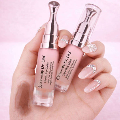 Pink-tinted lip gloss and lip treatment in clear tubes, two bottles held in hand