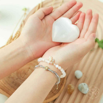 Bead bracelet set on palm with white stones and small gold charm details