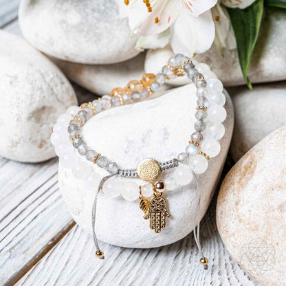 Stacked bracelet set with white beads and gold Hamsa hand charm