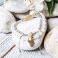 Stacked bracelet set with white beads and gold Hamsa hand charm