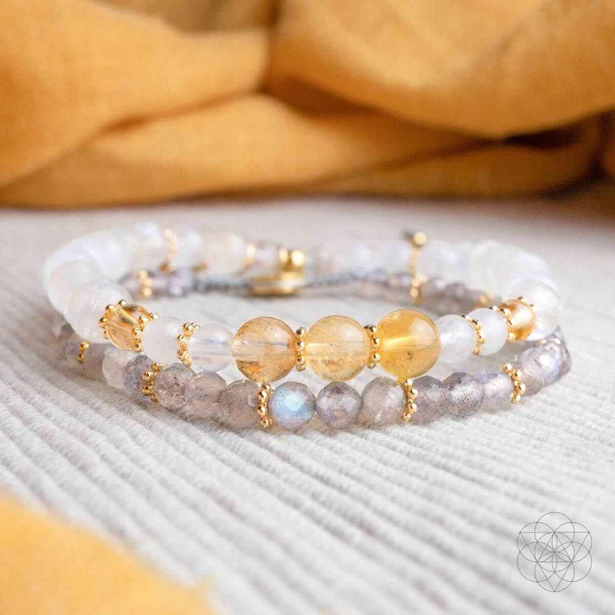 Close-up bead bracelets with white, amber stones, and gold-tone spacer beads