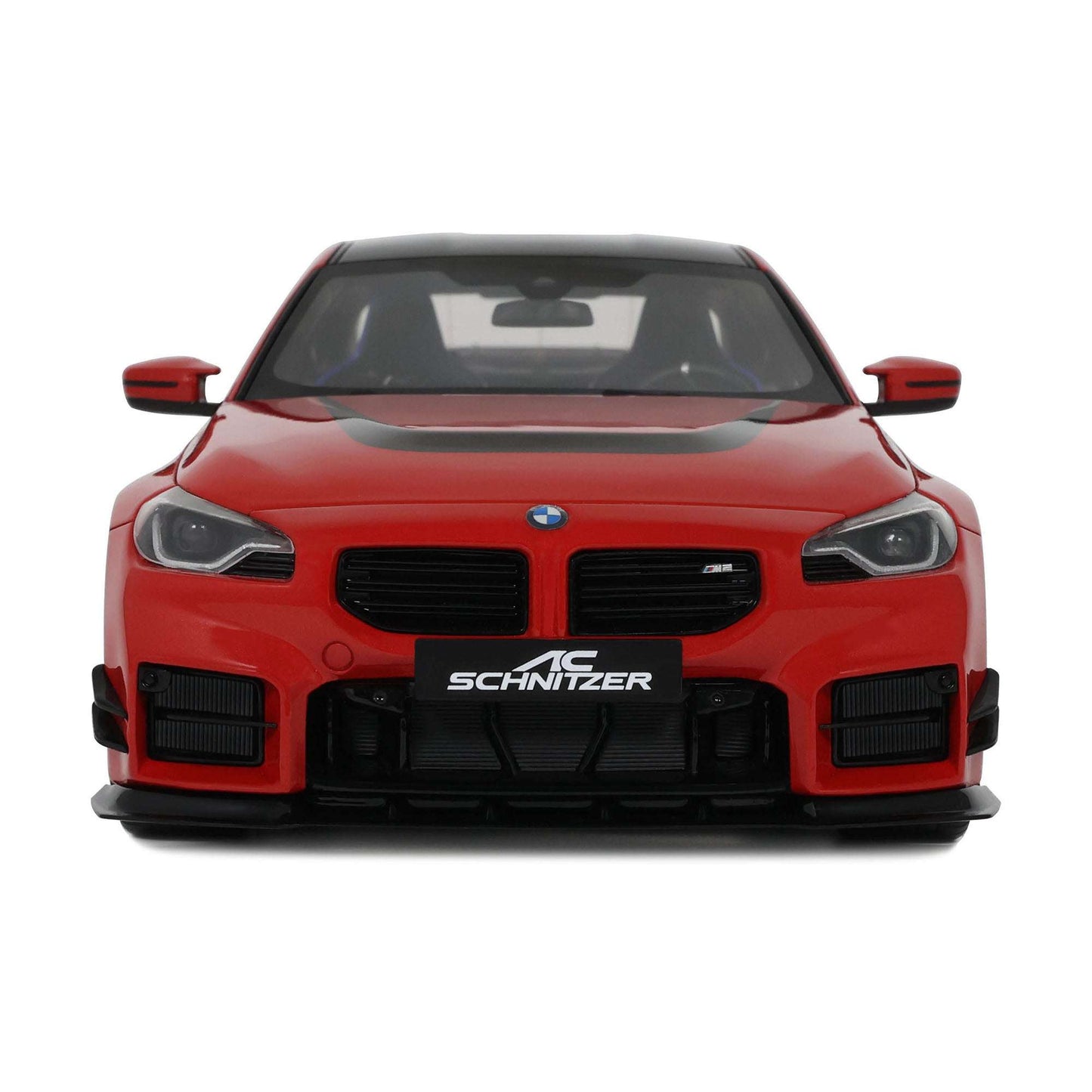 Red die-cast sports car model front view with black grille and SCHNITZER badge
