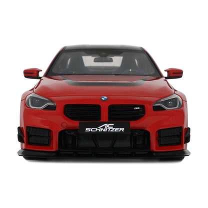 Red die-cast sports car model front view with black grille and SCHNITZER badge
