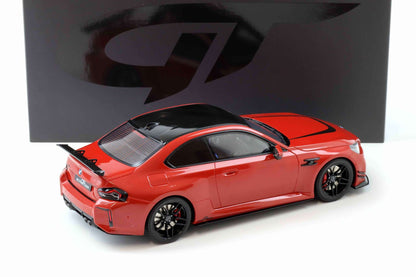 Red die-cast sports car model with black wheels and rear spoiler, 3/4 view