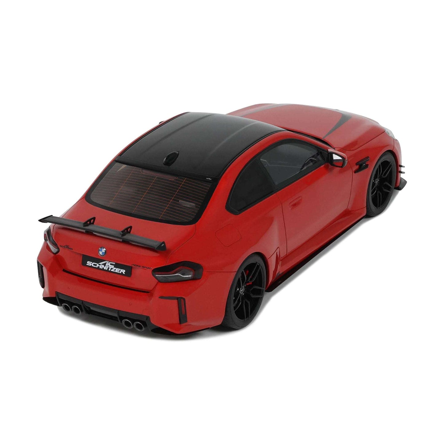Red die-cast model car with black hood and SCHNITZER rear details, rear wing