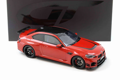 Red die-cast sports car model with black wheels and side vents, angled view