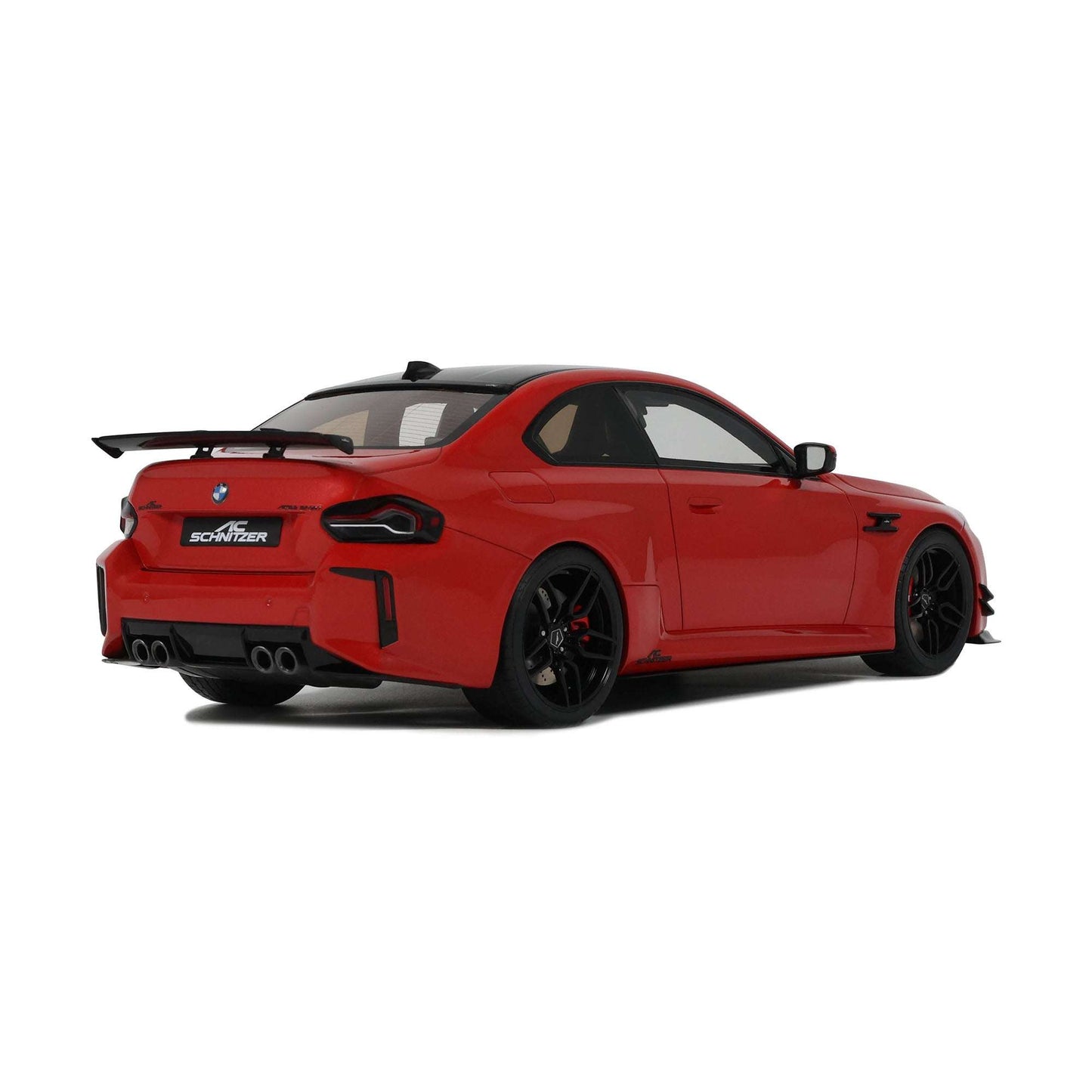 Red die-cast sports car model rear 3/4 view with black diffuser and wheels