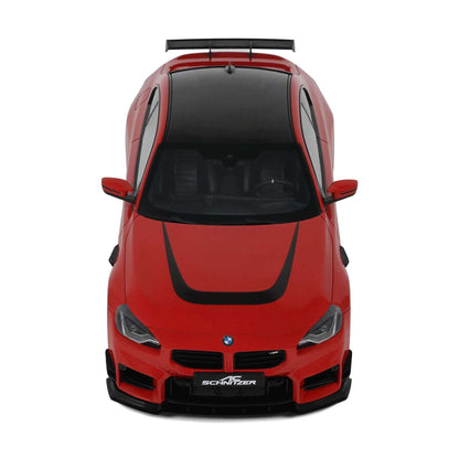 Red die-cast model car front view with black grille, headlights, and roof spoiler