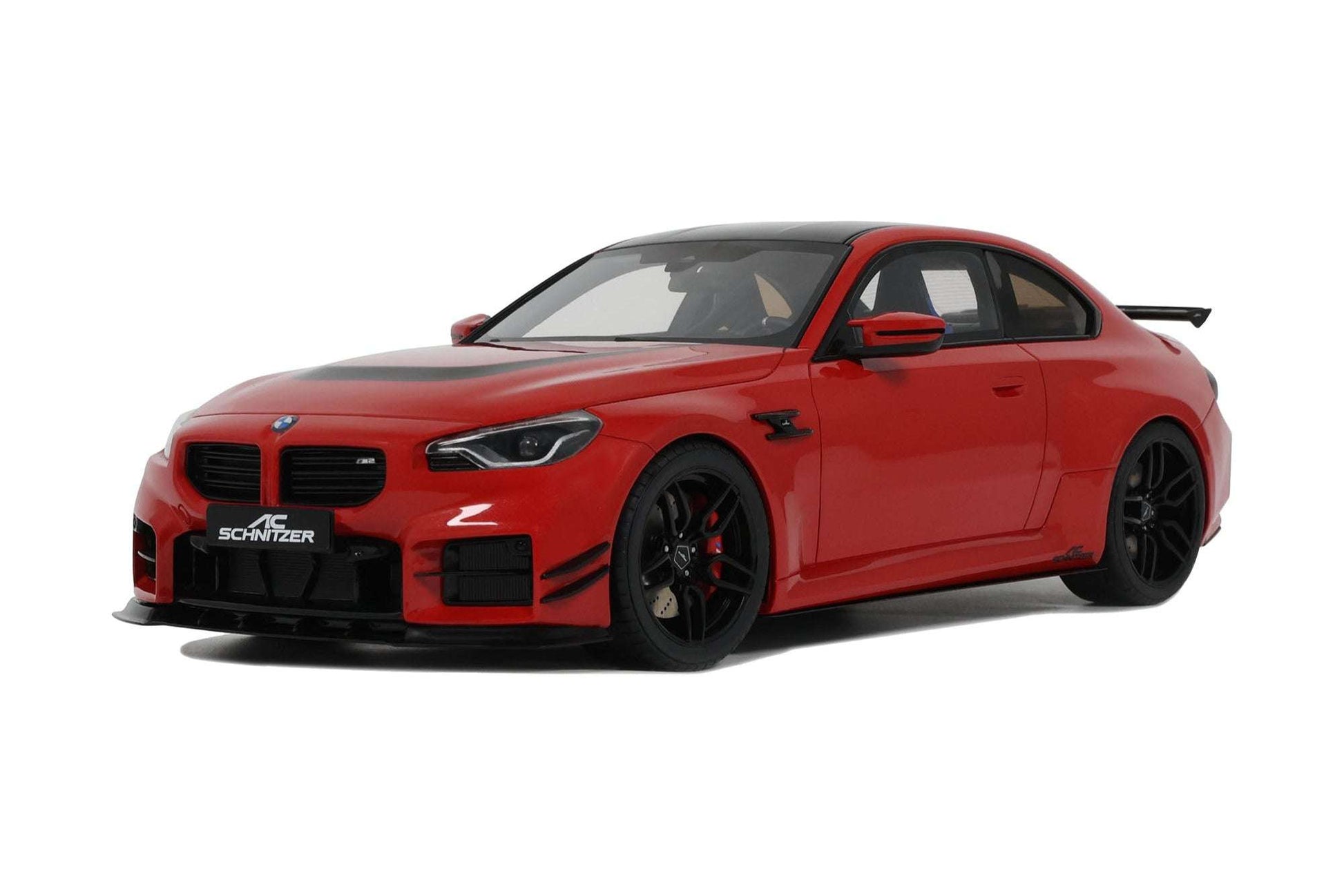 Red die-cast sports car model front view with black grille, headlight details