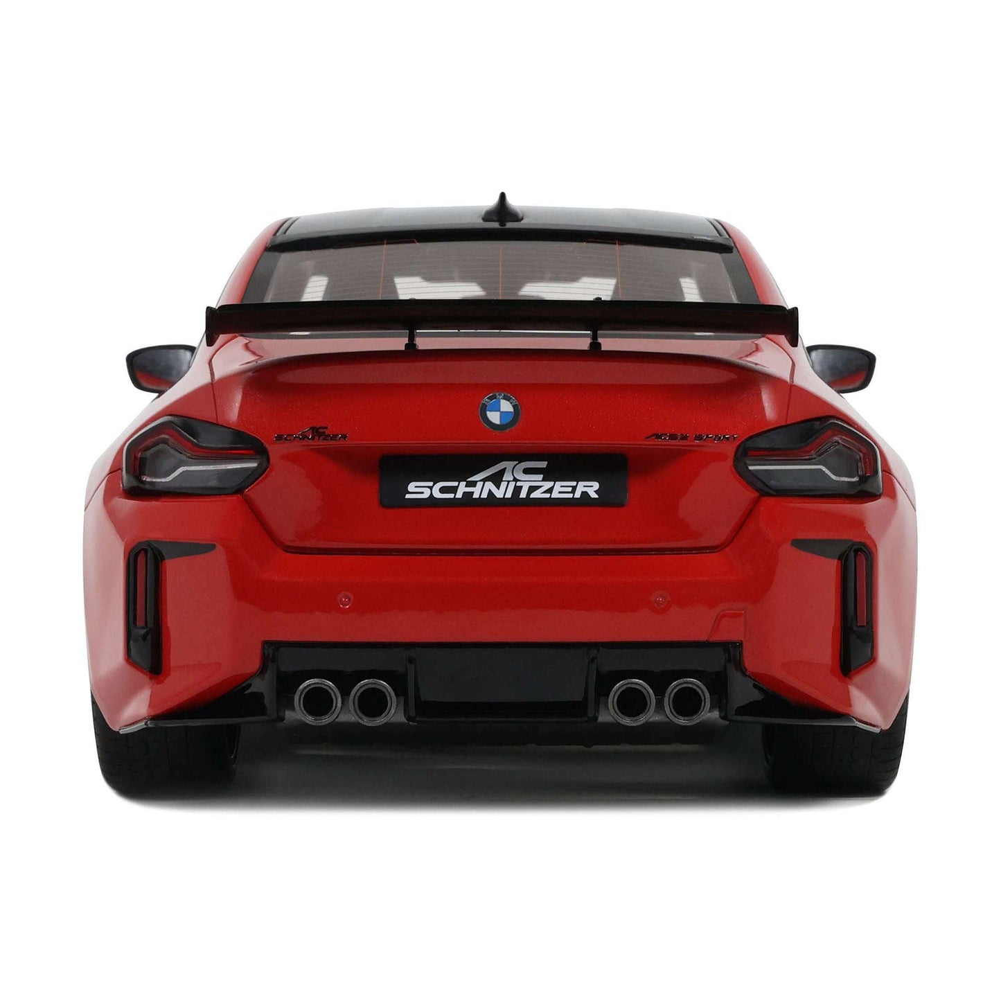 Red die-cast sports car model rear view with SCHNITZER badge and dual exhausts