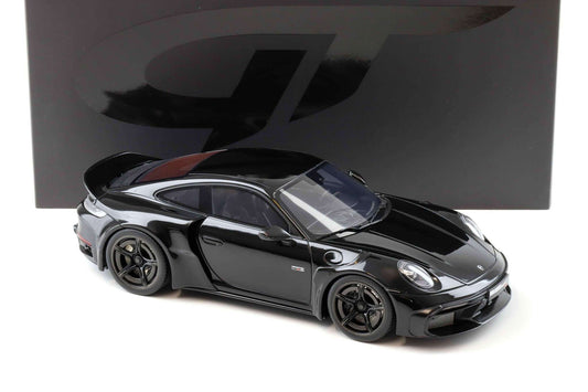 Black die-cast Porsche model car, side three-quarter view with black wheels and mirrors