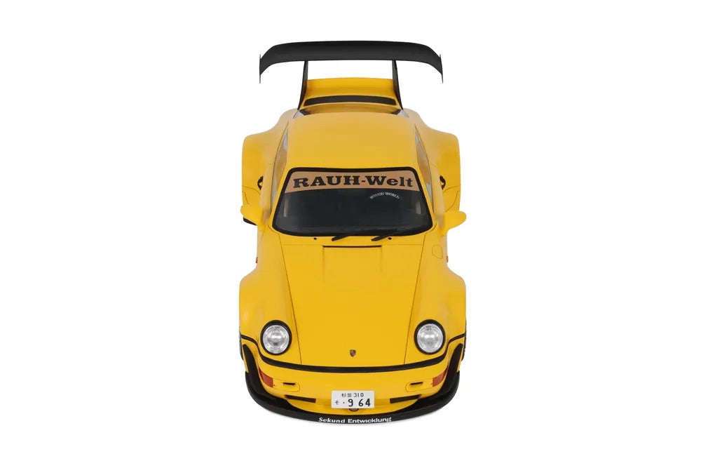 Yellow die-cast model car, front view with black grille and headlights