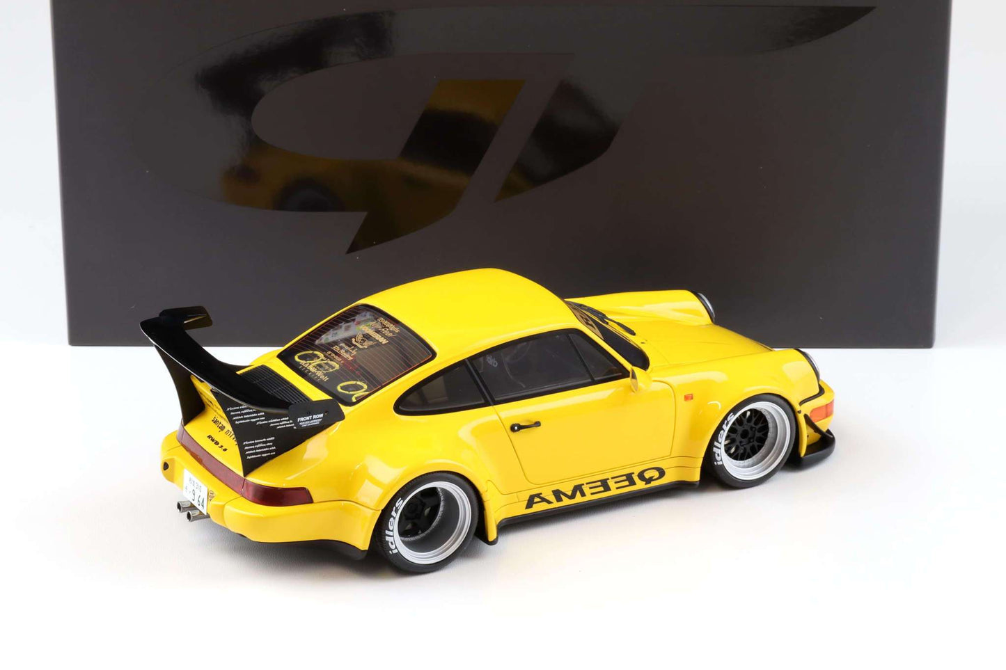 Yellow 1:18 scale Porsche 911 RWB diecast with rear three-quarter view and AMEDEQAM decals
